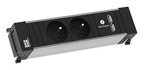 Egy téglalap alakú elosztó két hálózati aljzattal és két USB-csatlakozóval. Felül az 'USB Töltő' felirat olvasható.