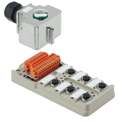 Egy elektronikus modul több csatlakozóval és egy nagyobb ezüstös résszel, amelyen egy zöld gomb van, valószínűleg egy vezérlőegység.