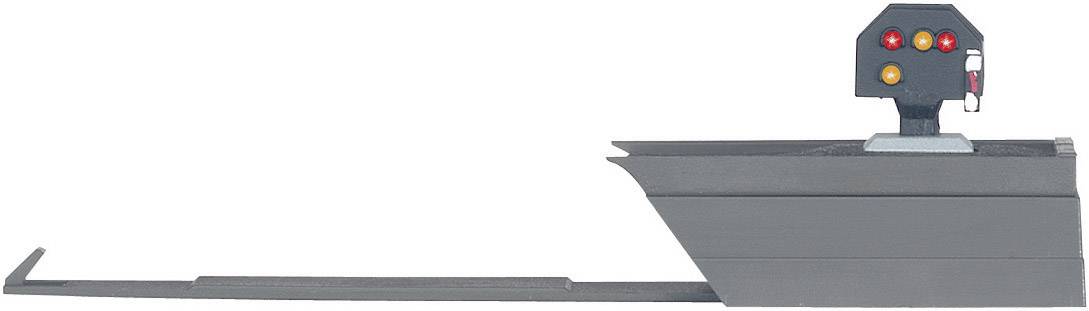 Egy modellvasúti jelzőlámpa három világító fénnyel: piros, sárga és zöld. A jelzőlámpa a vonatok üzemi állapotát mutatja.