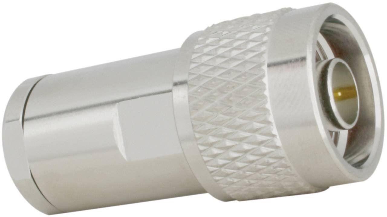 Egy ezüstszínű RF-csatlakozó bordázott felülettel és kerek nyílással, amelyet nagy frekvenciájú komponensek összekapcsolására használnak.