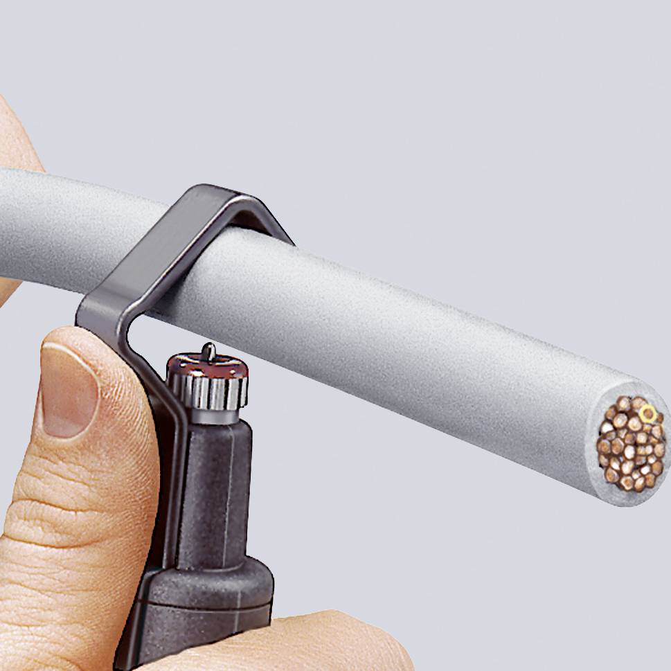 Una mano tiene in presa un manico di utensile agganciato a un cavo grigio, pronta a tagliarlo o aprirlo.