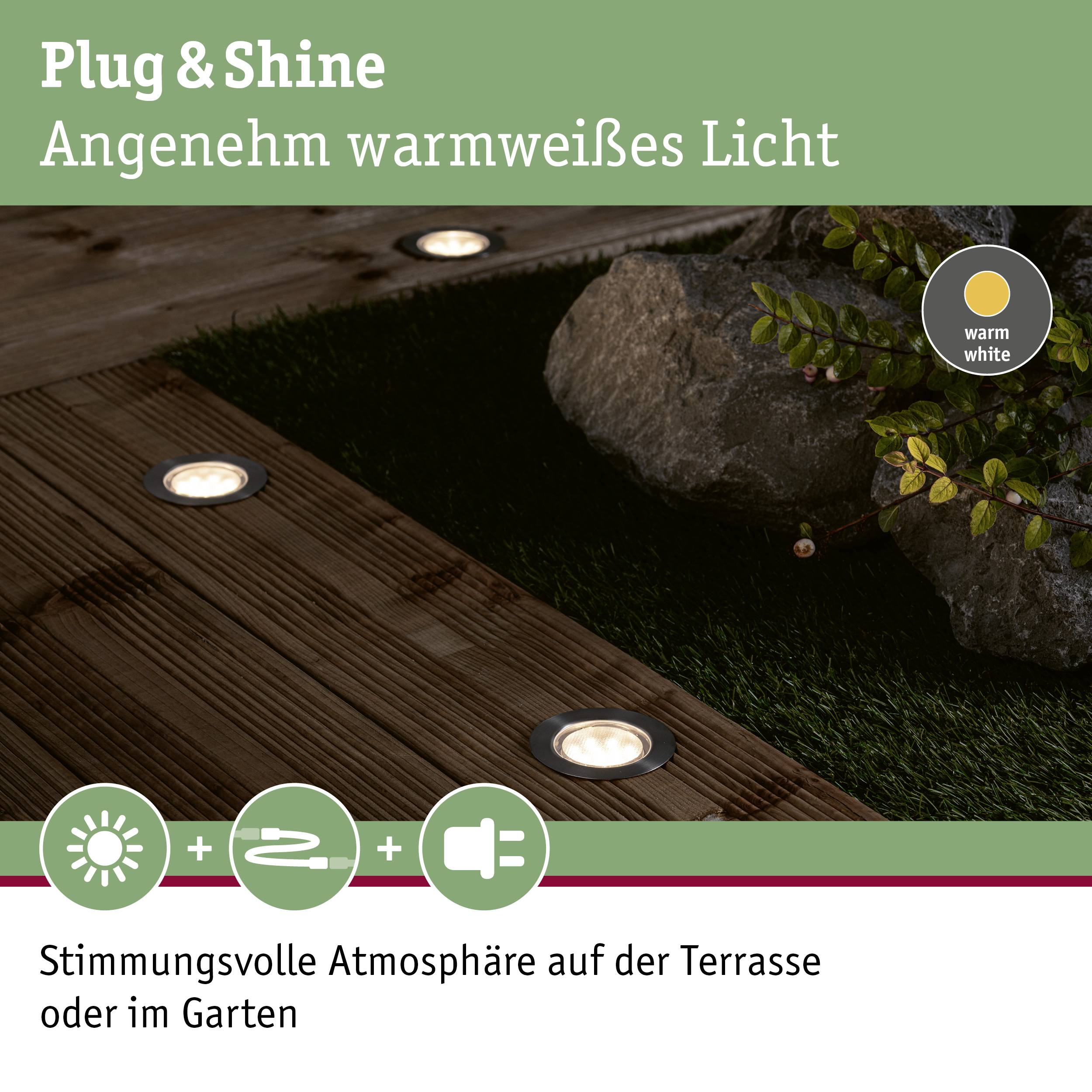 Plug & Shine faretti da giardino posizionati accanto a un masso, creano un'illuminazione calda e suggestiva per il patio o il giardino.