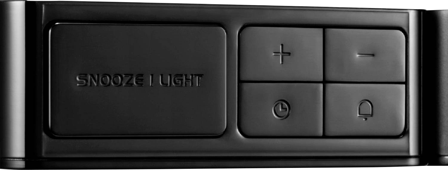 Superficie nera lucida di un dispositivo con tasti: '+', '−', simbolo dell'orologio e simbolo della campana. Area 'SNOOZE/LIGHT' a sinistra.