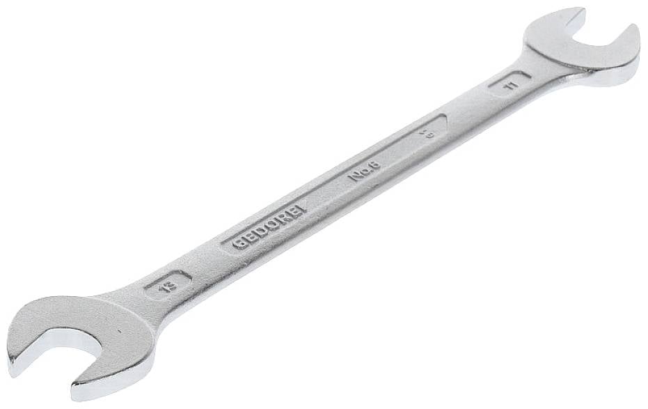 Una chiave inglese in argento con dimensioni di 12 e 13 mm, poggiata su una superficie chiara.