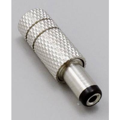 Un connettore metallico argentato con superficie zigrinata e estremità nera giace in modo obliquo su una superficie grigia.