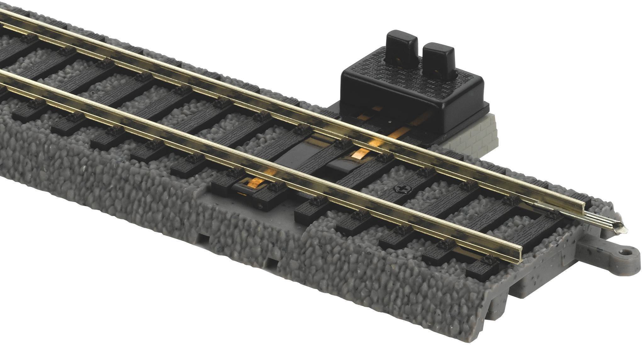 Interruttore ferroviario su binario grigio con meccanismo di contatto integrato per il controllo di treni modello elettrici.