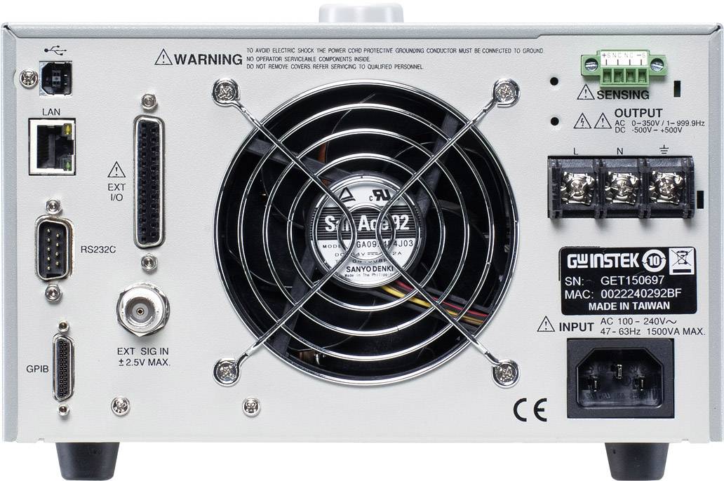 Retro di un alimentatore con ventola centrale, vari connettori e interruttori. Adesivo con dati tecnici e avvertenze sulla destra.