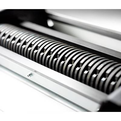 Primo piano di un cilindro metallico dentato in una macchina, probabilmente parte di un sistema di stampa o di laminazione.