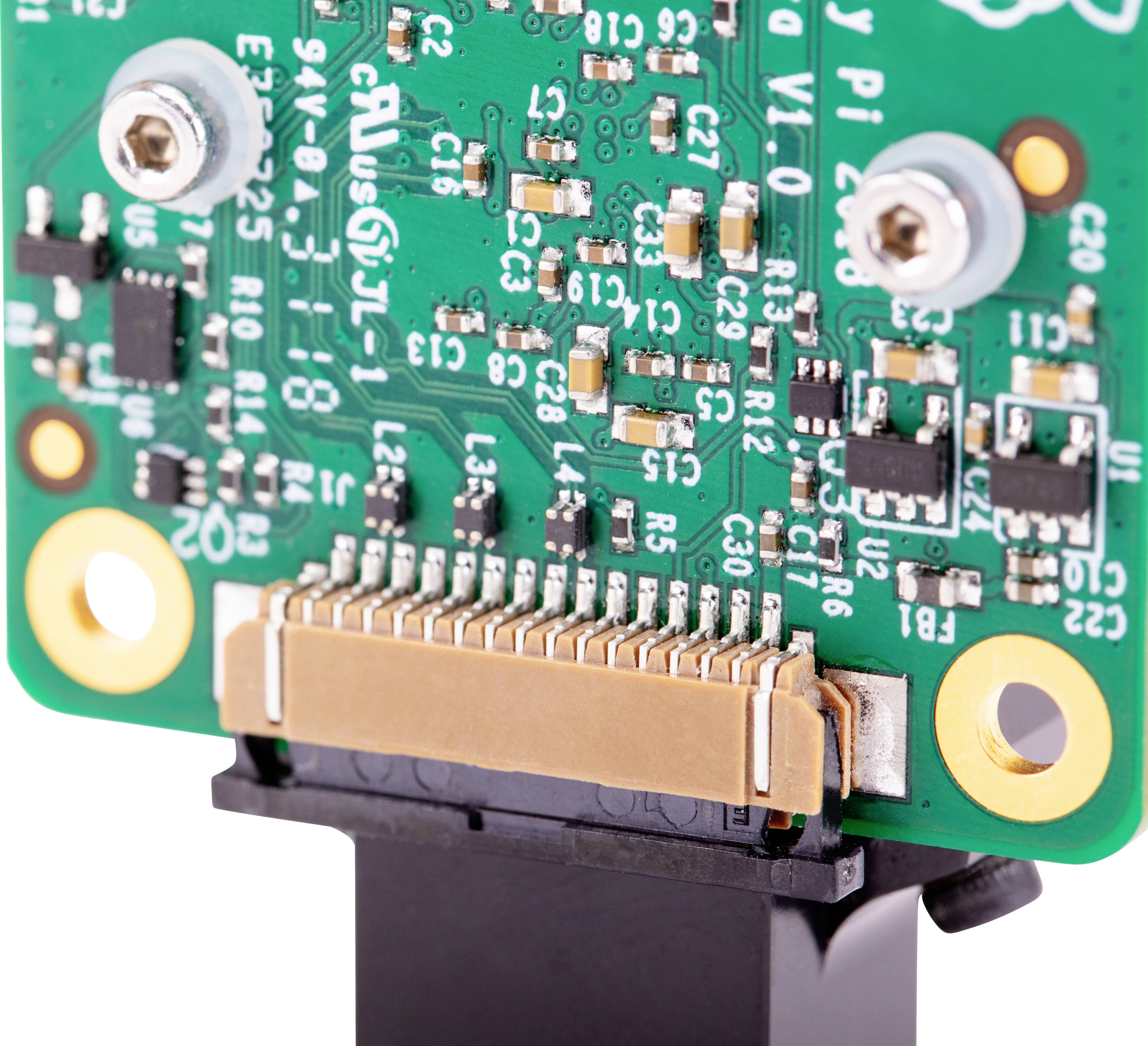 Primo piano di un circuito stampato verde con componenti elettronici e connettori, probabilmente appartenente a un dispositivo elettronico.