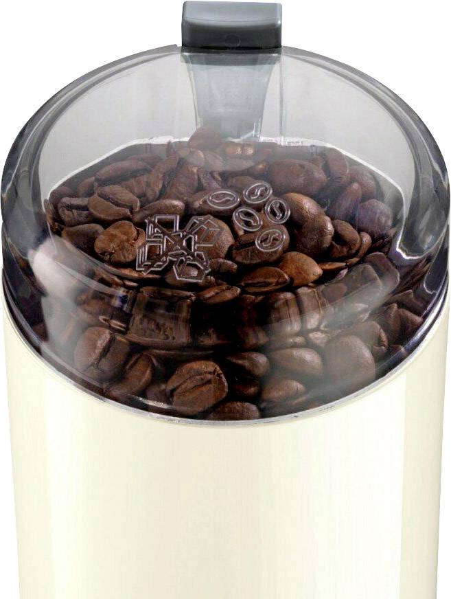 Un coperchio trasparente mostra i chicchi di caffè in un contenitore con un segno di macinatura del caffè sopra.