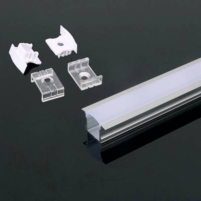 Un kit di profilo in alluminio per LED con una lunga guida a destra e quattro clip di montaggio a sinistra, su uno sfondo scuro.