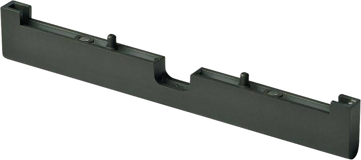 Un pezzo nero e allungato in plastica con diverse sporgenze sulla superficie superiore, probabilmente un componente tecnico o un supporto.