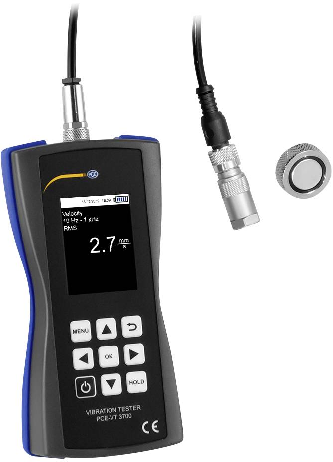 Tester portatile di vibrazione con display digitale indica '2,7 m/s'. Utilizzato per misurare velocità, frequenza e valori RMS. Sensore rimovibile collegato.