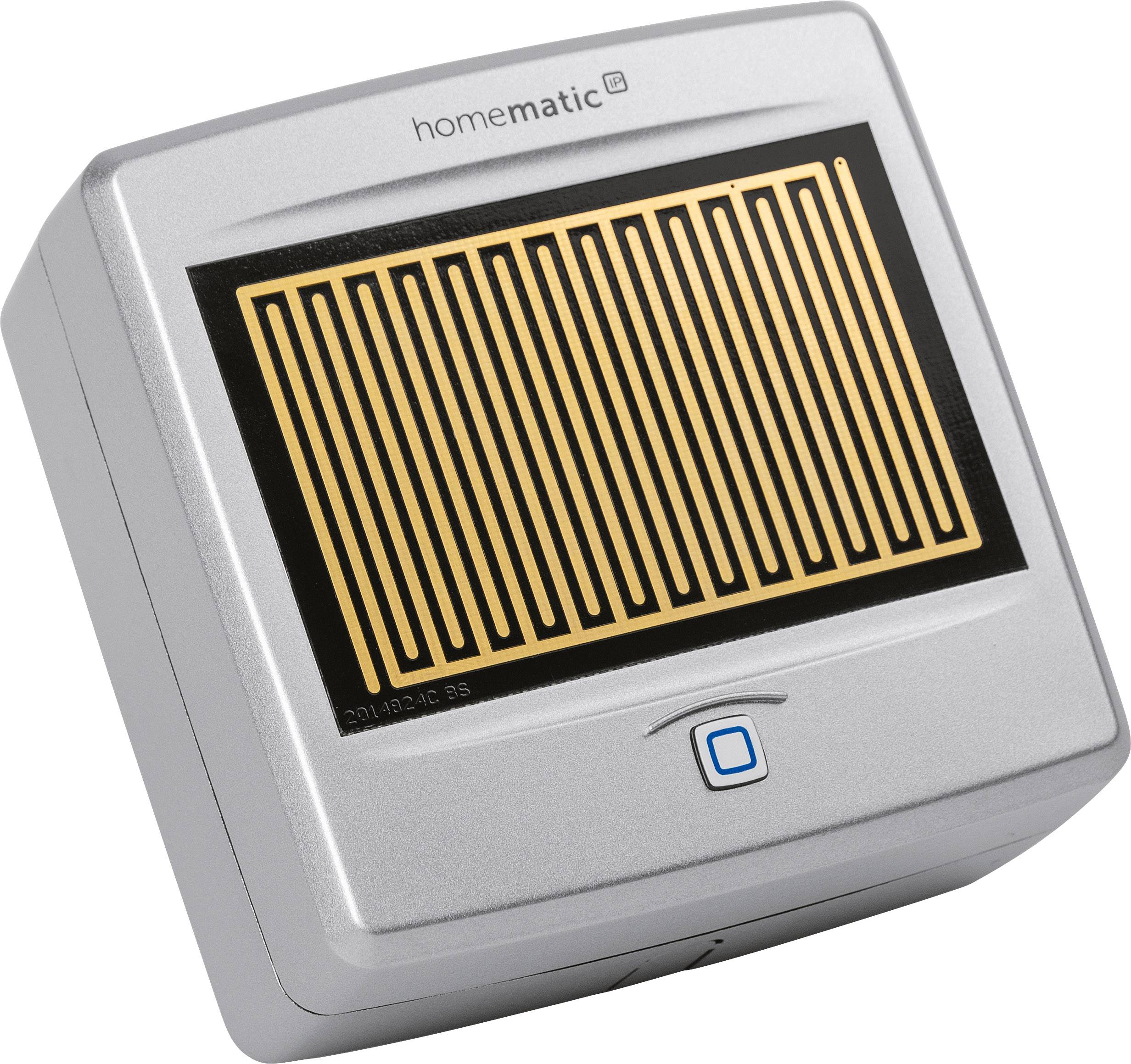 Un dispositivo elettronico argentato del marchio Homematic con un sensore rettangolare e un pulsante quadrato sottostante.