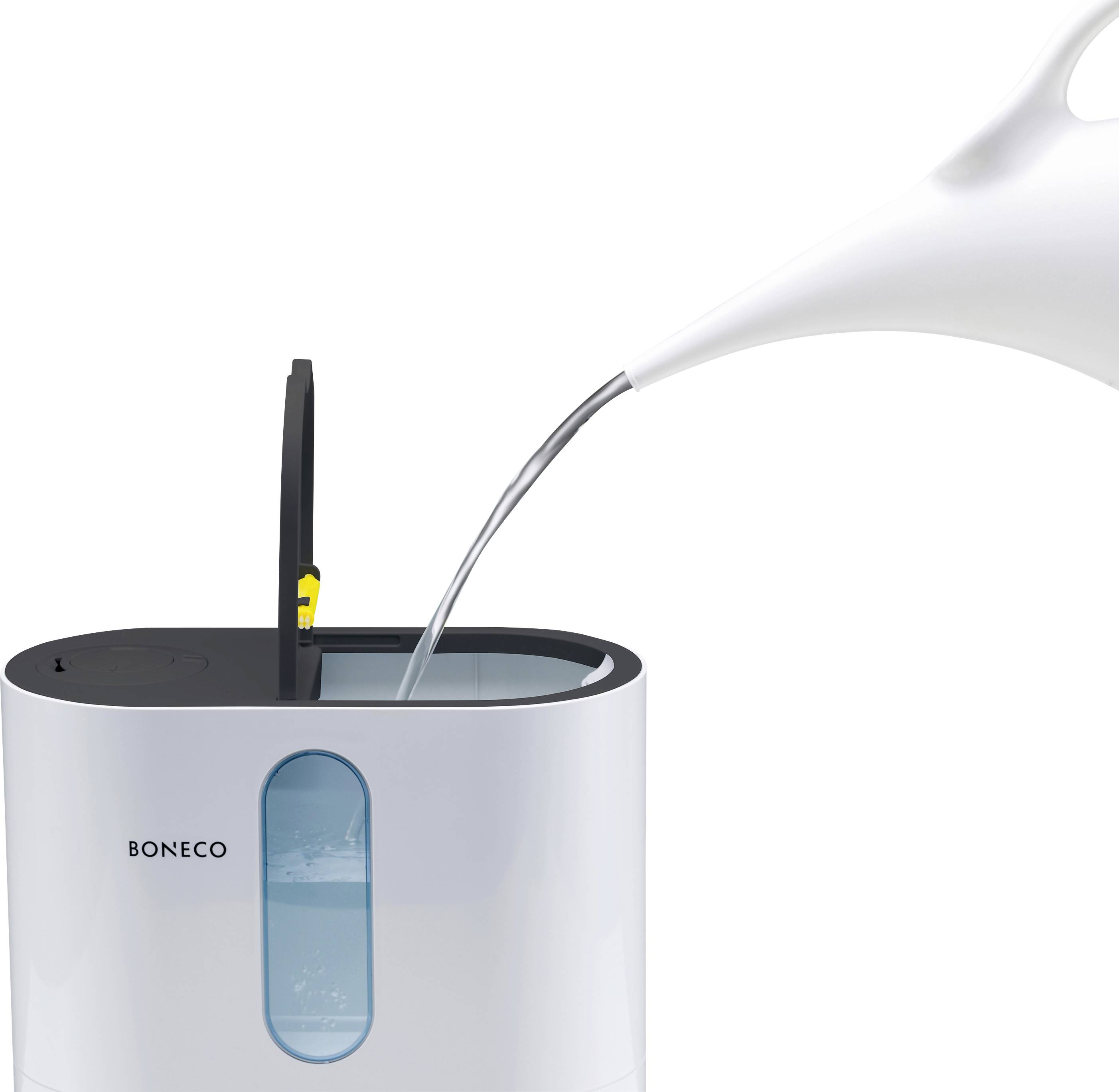 Umidificatore con contenitore dell'acqua aperto, in cui viene versata acqua da una brocca bianca.