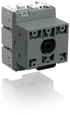 Un blocco interruttori elettrico grigio con design quadrato, multiple fissazioni a vite e un alloggiamento centrale per il fissaggio o l'azionamento.