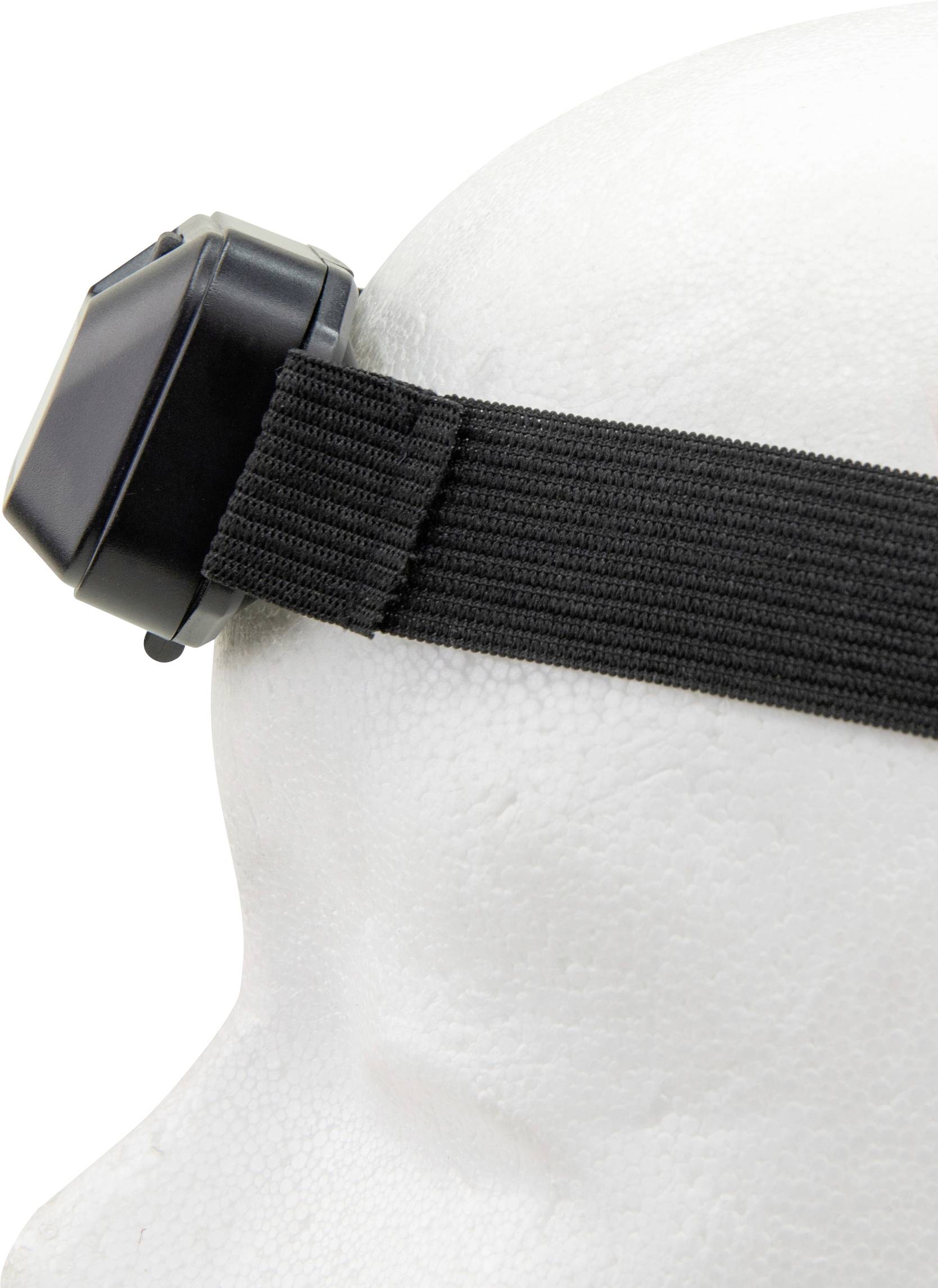 Una fascia nera per la fronte con un dispositivo sul lato, fissata a una testa di manichino bianca.