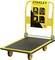 Carrello piattaforma giallo Stanley con piano di carico nero. Portata massima 300 kg, dimensioni 61 cm x 91 cm, manico pieghevole.