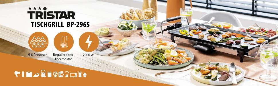 Una cucina con un tavolo su cui si trova una griglia da tavolo con verdure come peperone e zucchina. Testo: 'Privo di BPA-PFOA', 'Rivestimento antiaderente'.