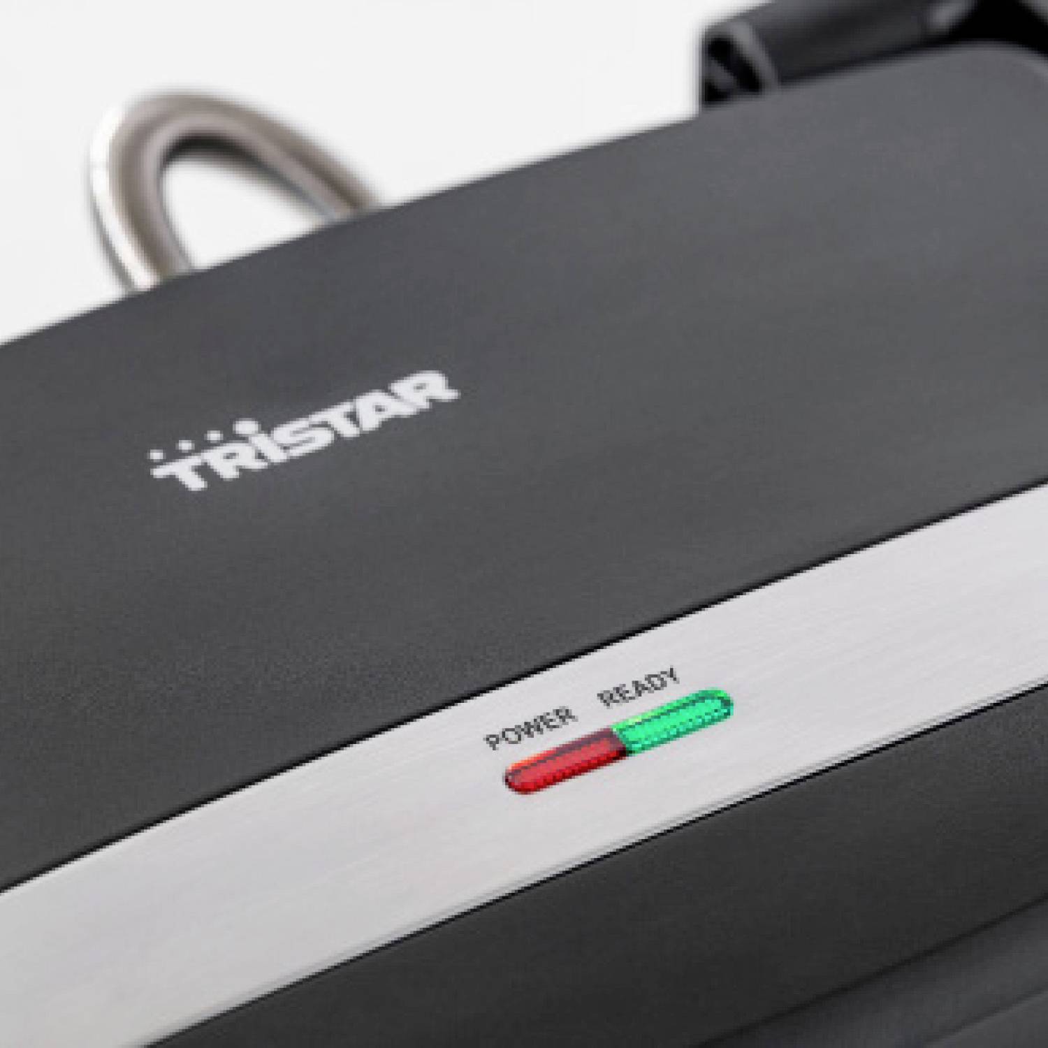 Griglia a contatto nera con striscia argentata e due spie di controllo sulla parte superiore.