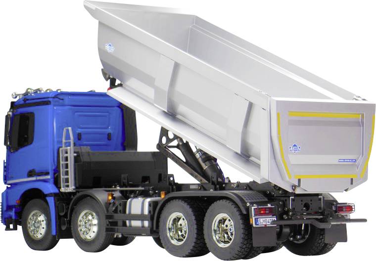 Un camion blu con un ampio pianale sollevato, pronto per scaricare i materiali.