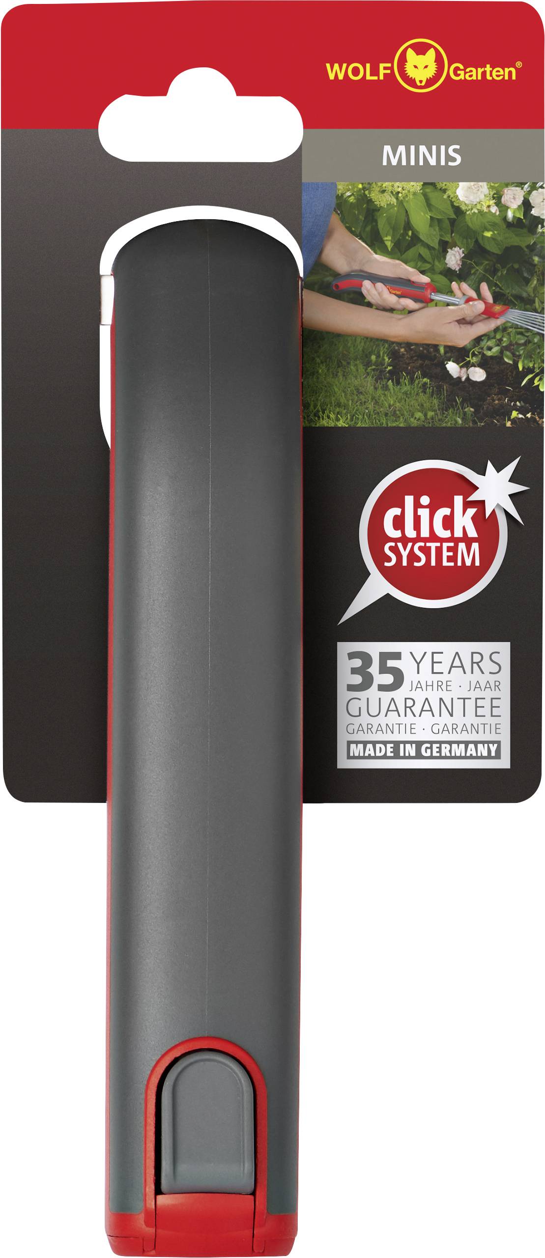 'WOLF-Garten' attrezzo da giardino in confezione, manico nero con accento rosso. Indicazione di '35 anni di garanzia' e 'Made in Germany'.
