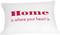 Un cuscino bianco con il testo rosso 'Home is where your heart is'.