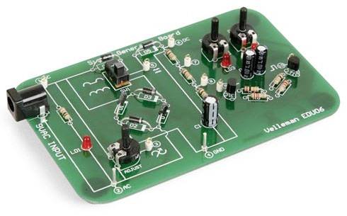 Scheda verde con componenti elettronici come resistenze, condensatori e interruttori. A sinistra è contrassegnato un ingresso di alimentazione con '9VAC INPUT'.