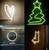 Quattro immagini: Un cuore al neon luminoso, un albero di Natale verde al neon, uno specchio illuminato in un bagno, e una freccia al neon rivolta in basso a sinistra.