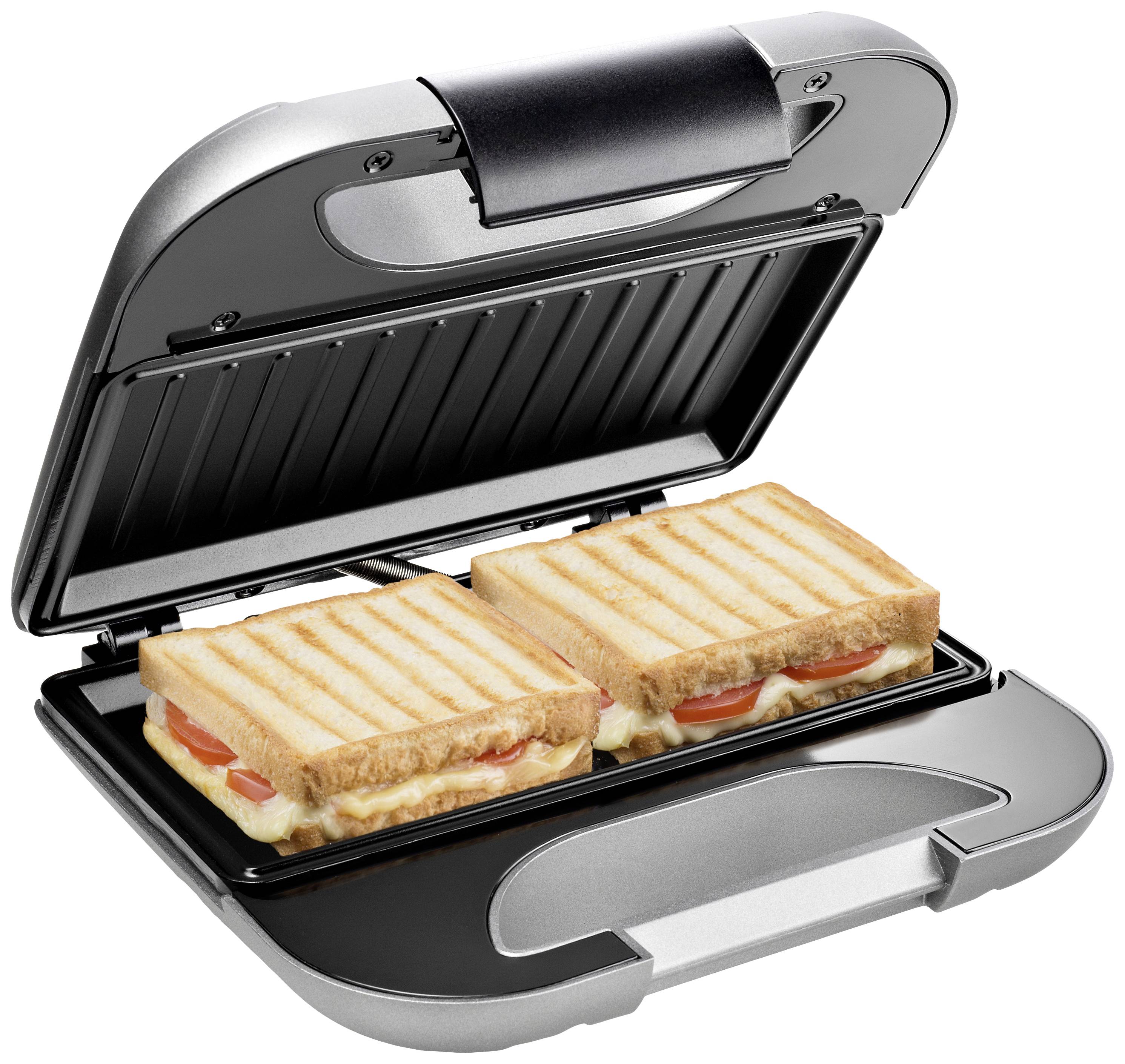 Un sandwich maker sta grigliando due toast farciti con pomodori e formaggio. L'apparecchio è aperto, i toast hanno le classiche striature della griglia.