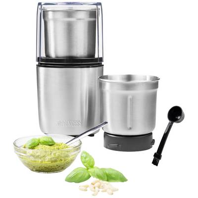 Macinacucina in acciaio inossidabile con due contenitori, accanto a una ciotola di pesto, un cucchiaio e foglie di basilico su sfondo bianco.