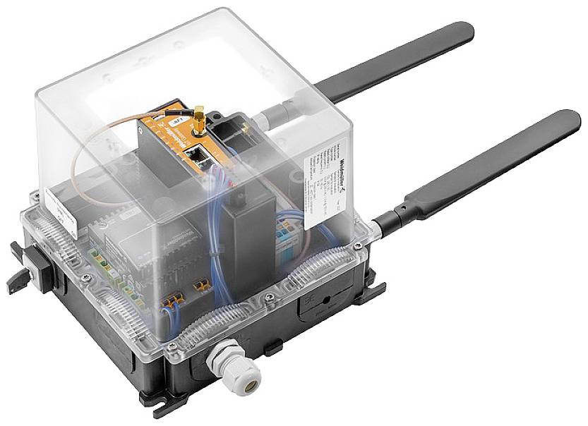 Dispositivo elettronico con coperchio trasparente, due antenne e diversi connettori, probabilmente un modulo di comunicazione.