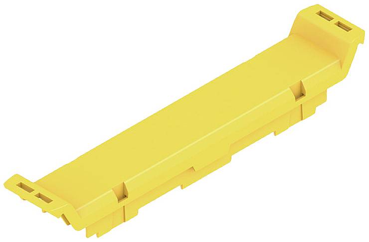 Pezzo in plastica gialla con forma rettangolare e estremità sollevate e leggermente inclinate. Aspetto chiaro, semplice e industriale.