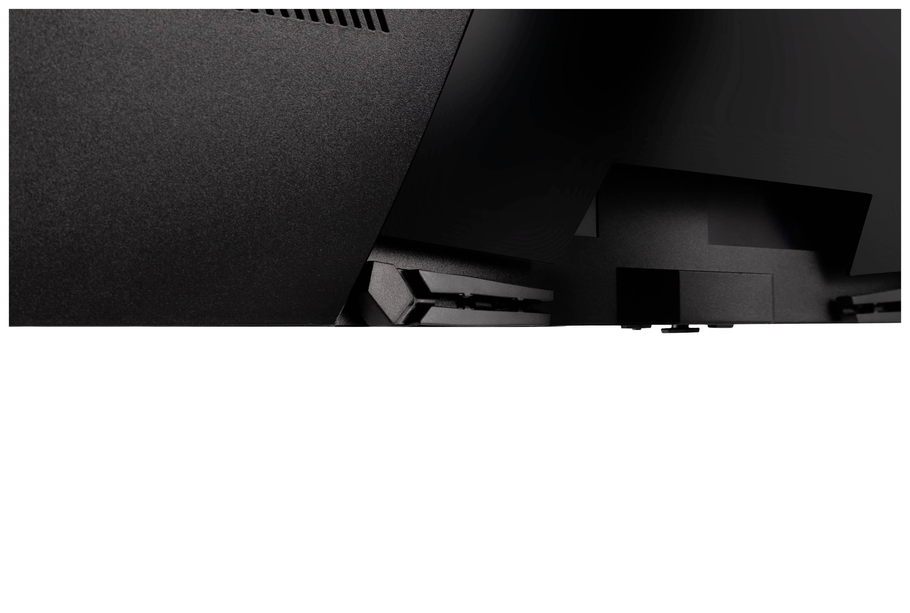 Retro di un monitor nero con fessure di ventilazione e aperture per le connessioni, parzialmente oscurate e senza marchi identificabili.