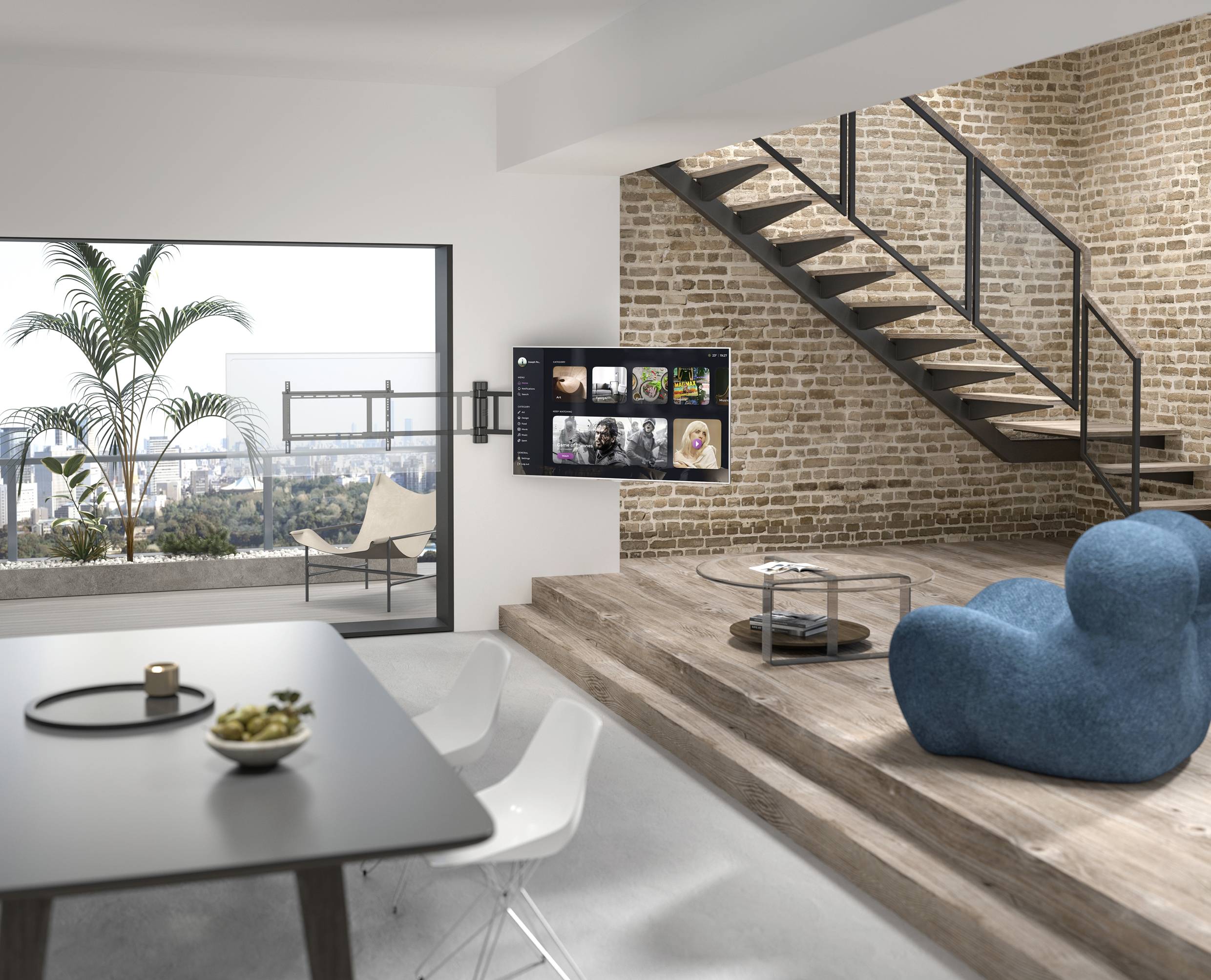 Appartamento moderno in stile loft con pareti in mattoni, scala, ampia finestra con vista sulla città; tavolo con ciotola e divano in primo piano.