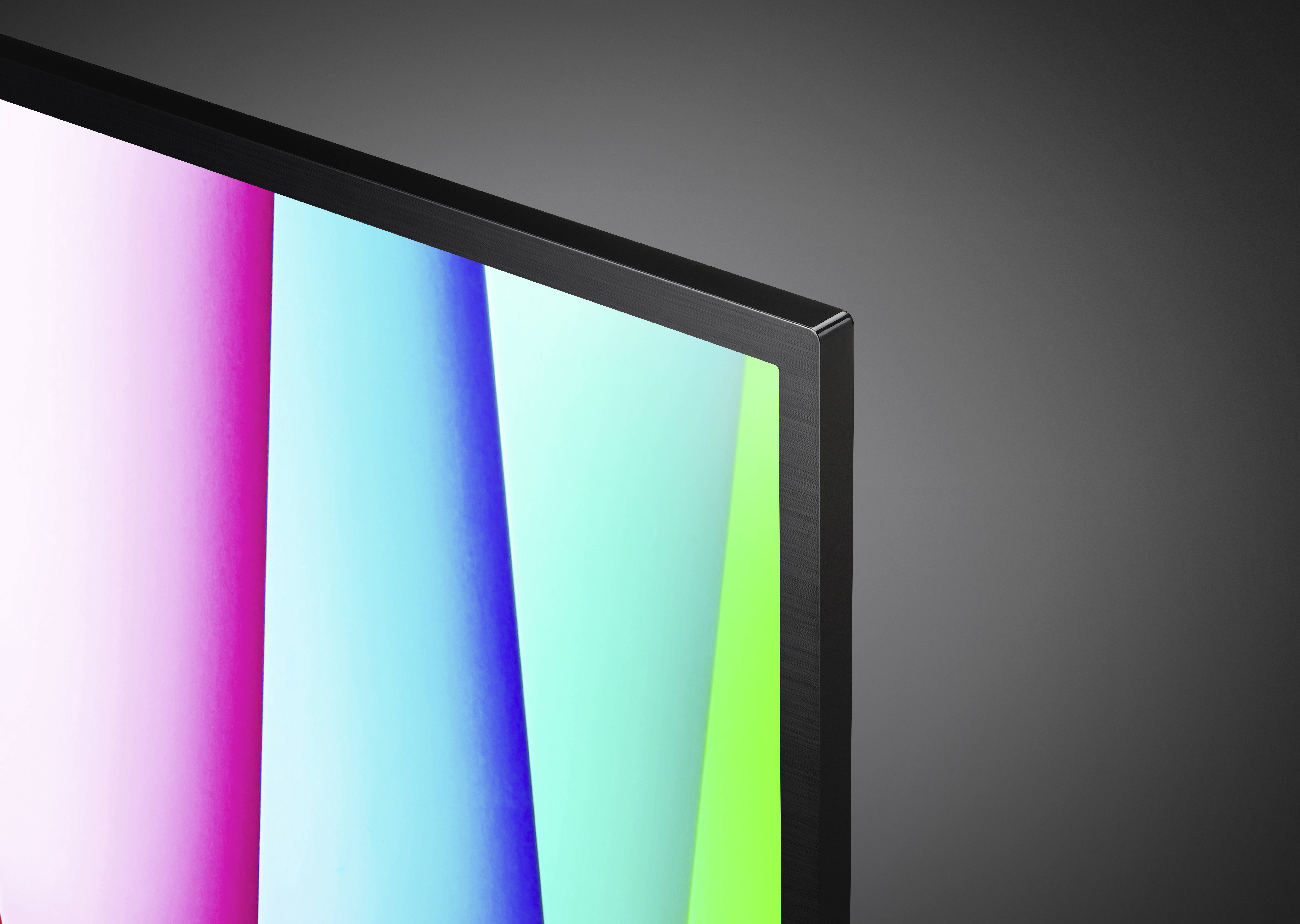 Primi piani di un televisore con cornice sottile che mostra strisce verticali colorate sullo schermo, su uno sfondo grigio.