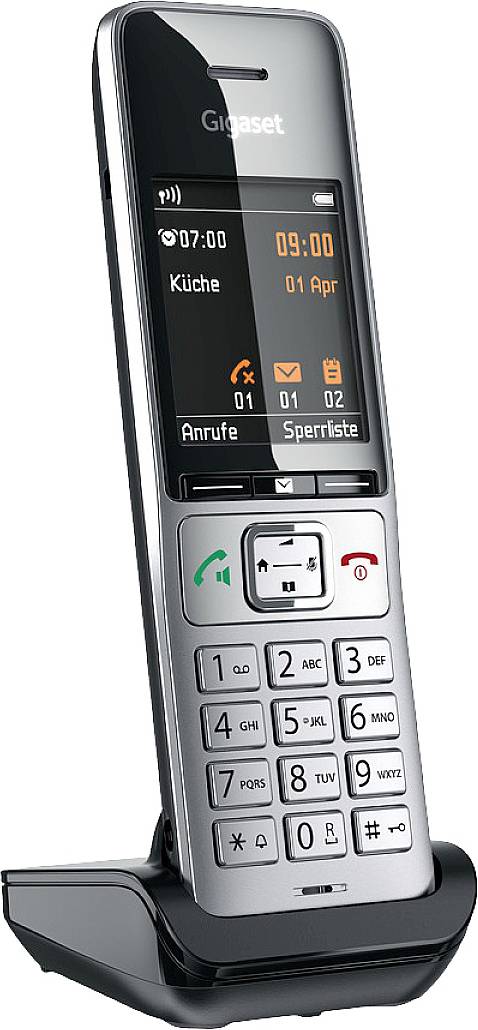 Telefono cordless nel supporto di ricarica. Il display mostra l'ora, la data e 'Cucina'. Tastiera con numeri e tasti funzione.