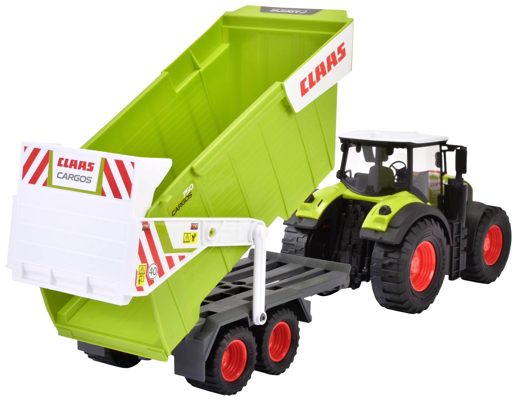Trattore giocattolo con rimorchio verde che mostra 'Claas Cargos'. Il rimorchio è sollevato, come se stesse scaricando qualcosa.