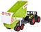 Trattore giocattolo con rimorchio verde che mostra 'Claas Cargos'. Il rimorchio è sollevato, come se stesse scaricando qualcosa.