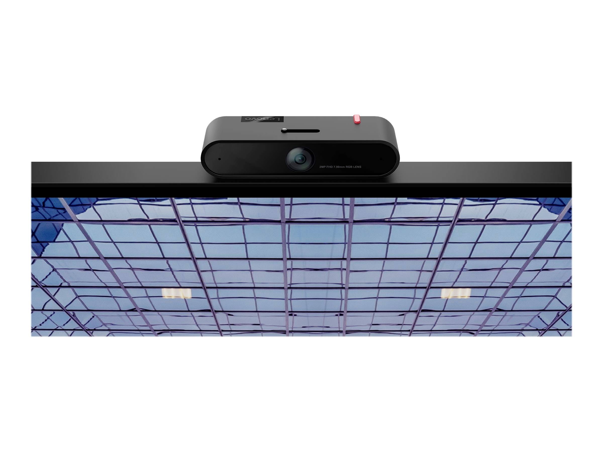 Fotocamera con obiettivo rettangolare e interruttore rosso sopra una finestra di un edificio con struttura di vetro blu.