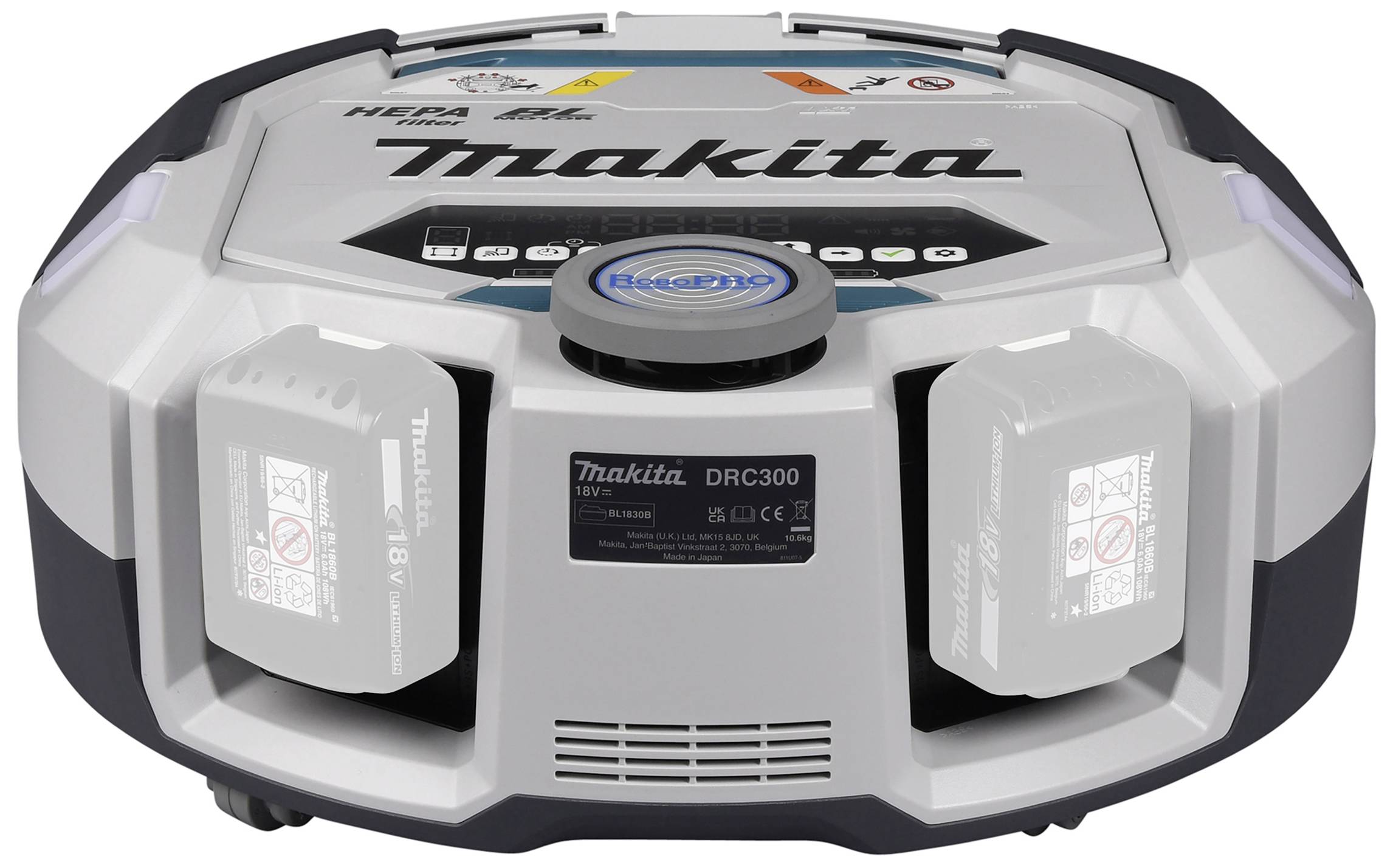 Un aspirapolvere robotico rotondo grigio con il nome del marchio 'Makita' sulla parte superiore. Ha due batterie estraibili.