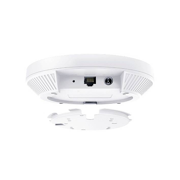 Un punto di accesso Wi-Fi bianco e rotondo visto dal basso, mostra una porta Ethernet e un attacco di alimentazione al centro della parte inferiore.
