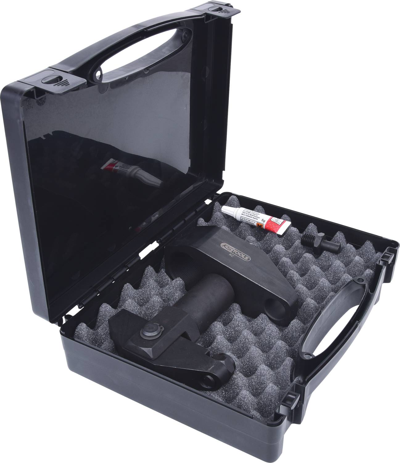 Una valigetta nera con imbottitura in schiuma contiene un utensile e accessori. Un piccolo tubetto è ugualmente incluso.
