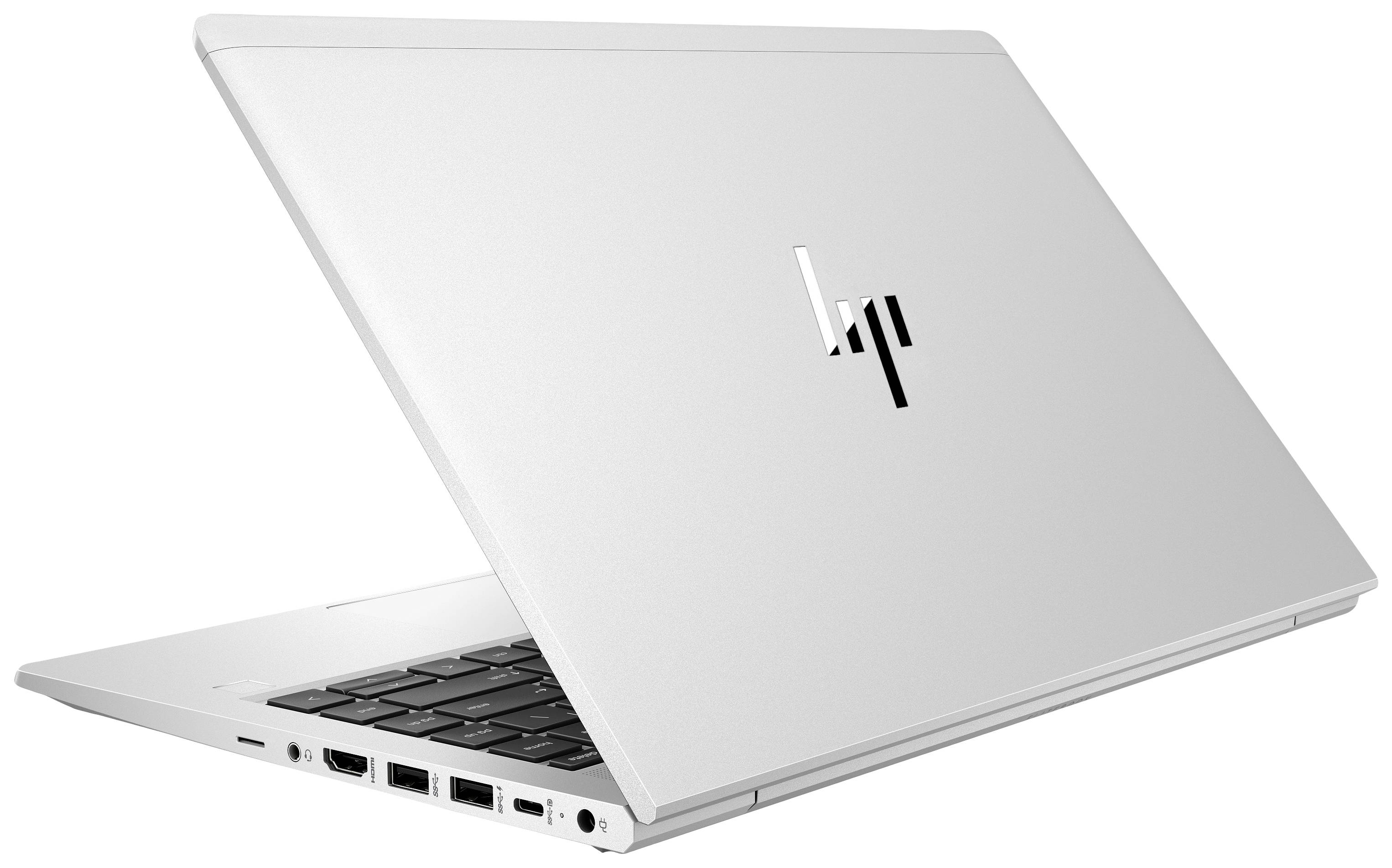 Laptop argentato parzialmente aperto, mostra le porte laterali e la tastiera. Design elegante e moderno con logo riflettente.
