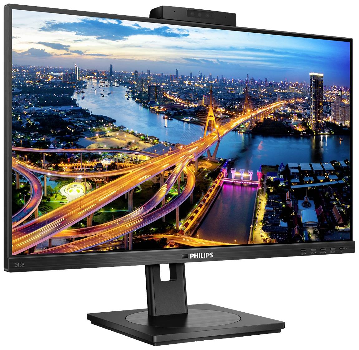 Un monitor del computer mostra una vivace veduta notturna di una città con ponti illuminati e grattacieli sullo sfondo.