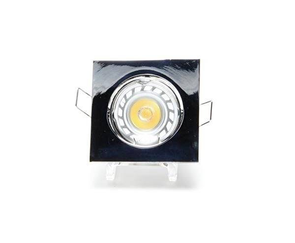 Un proiettore da soffitto quadrato nero con superficie lucida. Ha un elemento luminoso centrale rotondo.