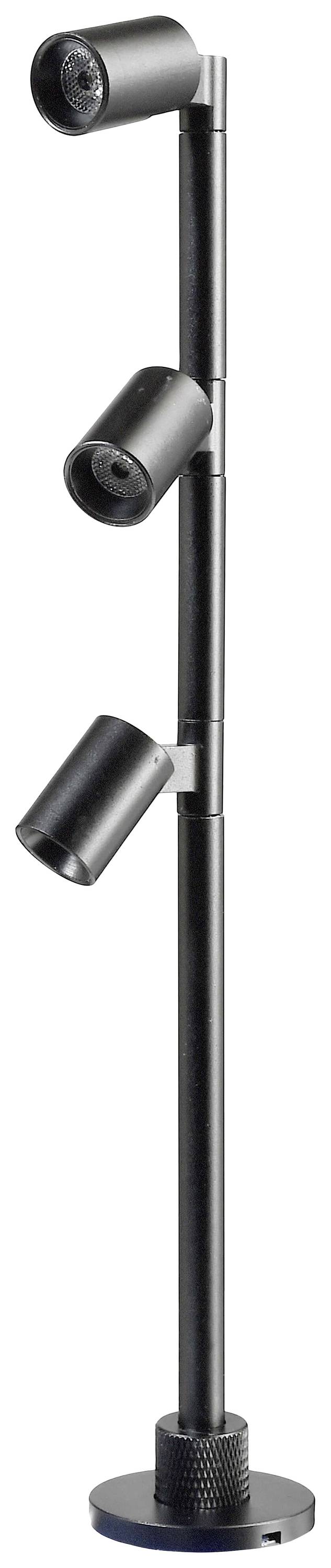 Lampada da terra nera con tre luci cilindriche regolabili poste su un'asta sottile, poggiante su una base rotonda.