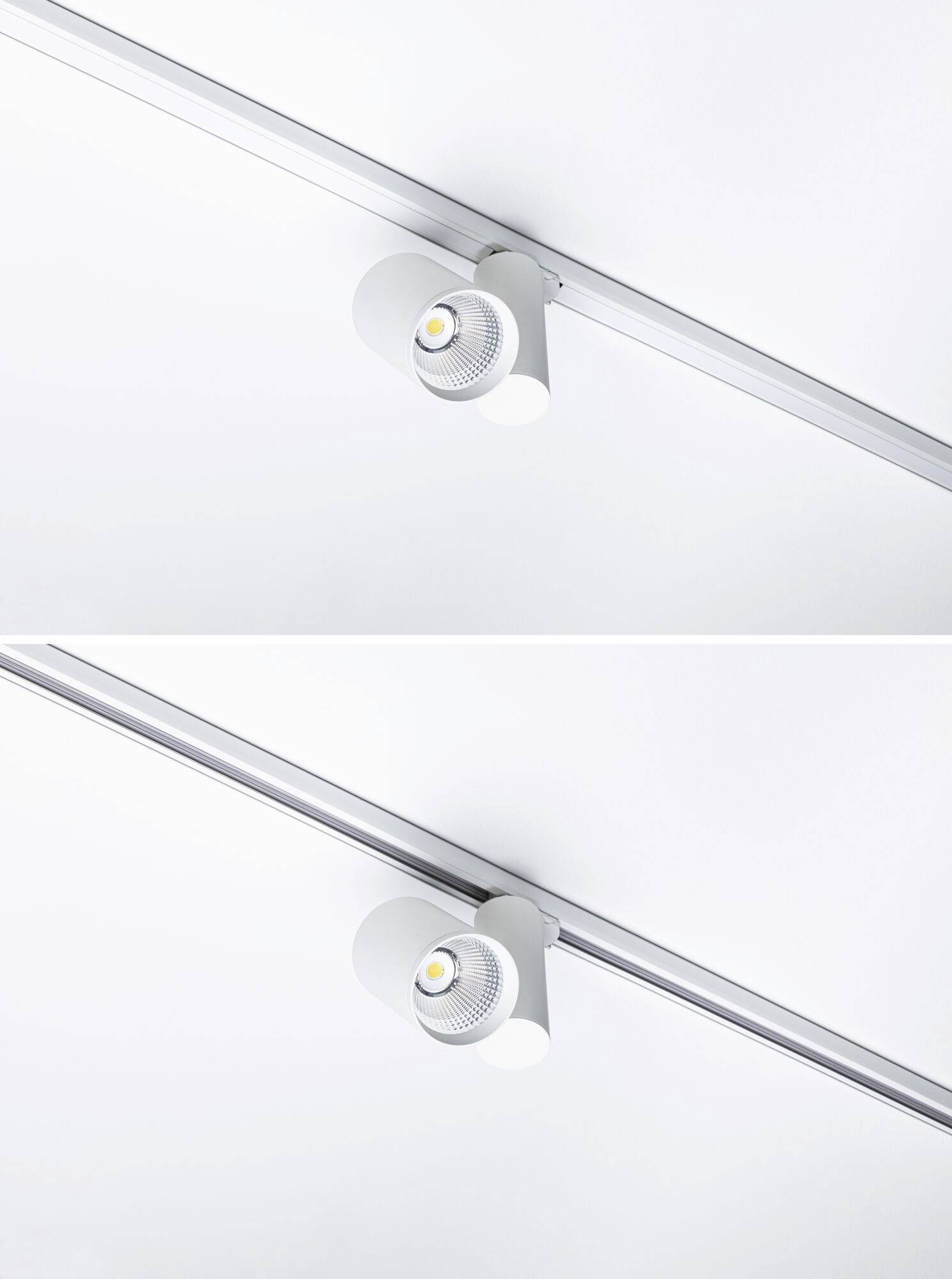 Due faretti bianchi montati su una guida, che appaiono luminosi e moderni.