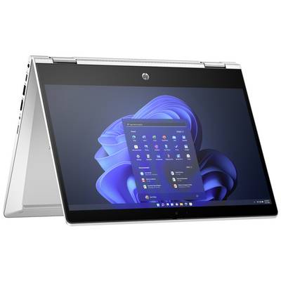 Un laptop in modalità tablet mostra il desktop di Windows con la barra del menu Start aperta su uno sfondo blu.