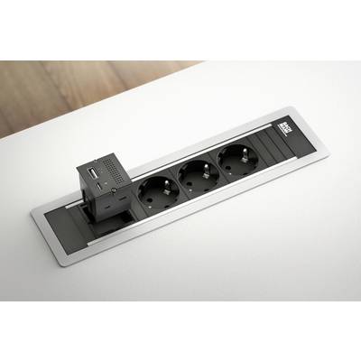 Modulo prese elettriche da tavolo con tre spine e un adattatore USB, racchiuso in un elegante cornice argentata.